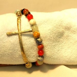 Multi colored beads with a gold tone hammered metal cross